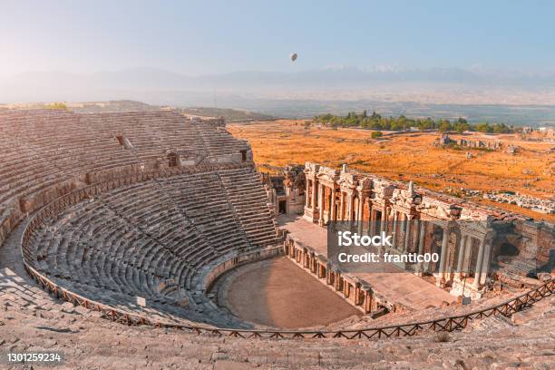 Ancient Greek Amphitheater In The City Of Hierapolis Near Pamukkale In Turkey Wonders And Travel Attractions Hot Air Balloon Above In The Morning Sky Stock Photo - Download Image Now