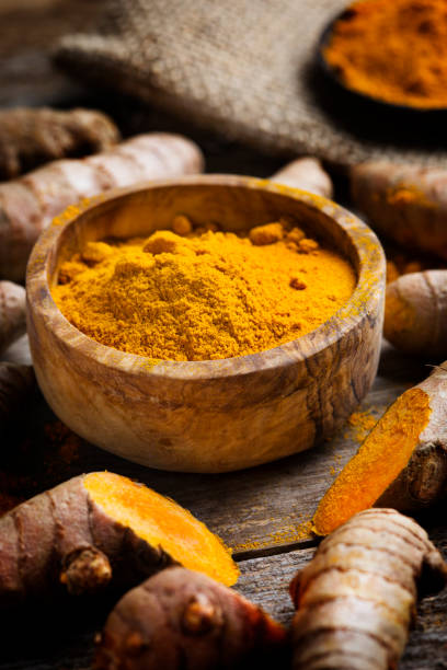 istock Curcuma longa, powder and rhizomes - complementary medicine 1301260098