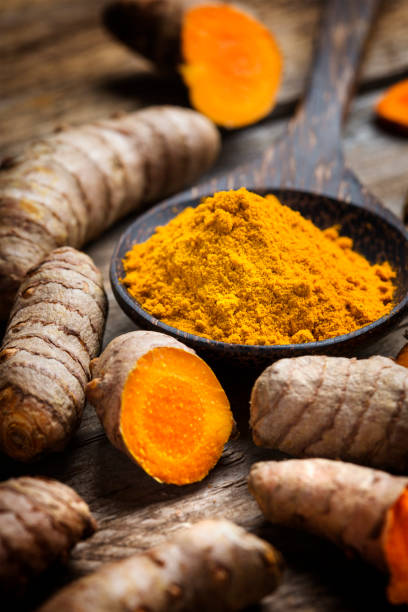 istock Curcuma longa, powder and rhizomes - complementary medicine 1301260118