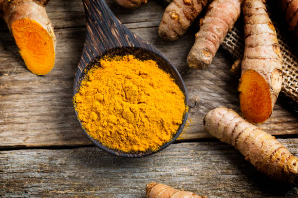istock Curcuma longa, powder and rhizomes - complementary medicine 1301260637