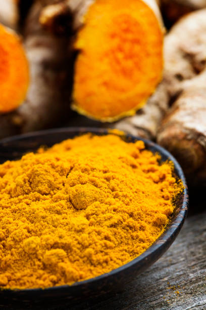 istock Curcuma longa, powder and rhizomes - complementary medicine 1301260647