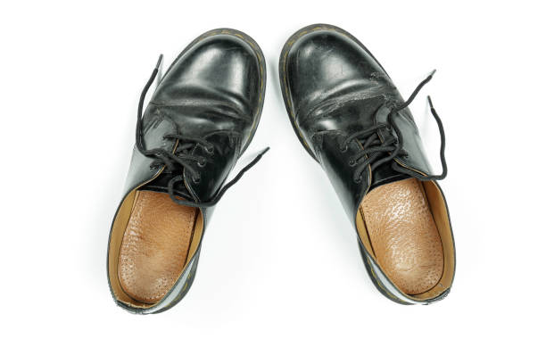 istock old, dirty, black leather shoes isolated on white 1301261578