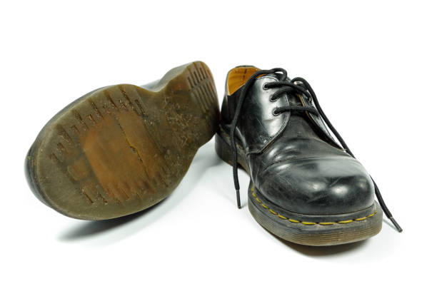 istock old, dirty, black leather shoes isolated on white 1301261585