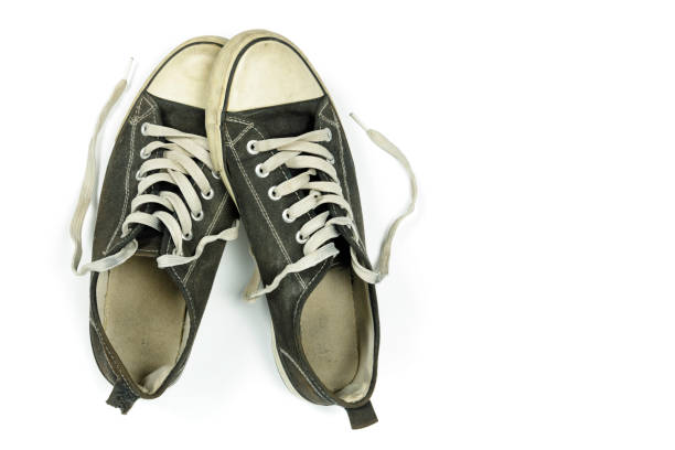 istock old, dirty trainers isolated on white 1301261615