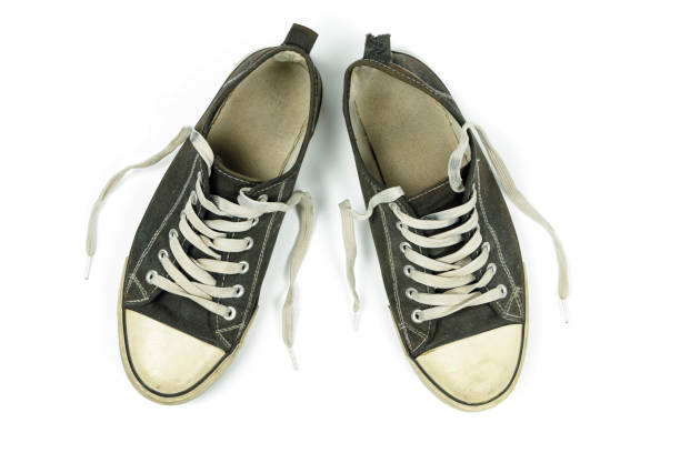 istock old, dirty trainers isolated on white 1301261634