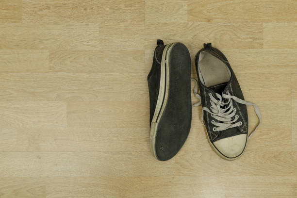 istock old, dirty trainers on a floor 1301261650