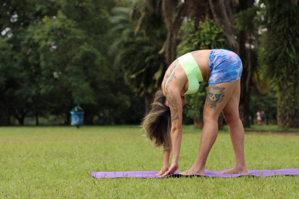 istock woman doing physical exercises outdoors 1301261674