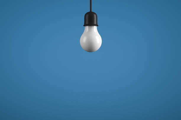 istock Hanging lamp on a blue background. Classic light bulb. Copy space. 1301262429
