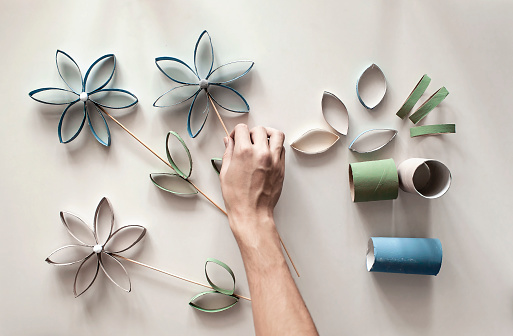 Flowers from toilet roll tube for Mother Day, zero waste crafts for kids, school and kindergarten, creative seasonal idea for holidays and leisure, plain neutral pastel background