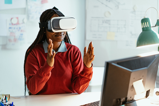African-American businesswoman using VR glasses in office