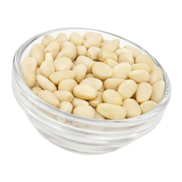 istock Pine nuts isolated against white background closeup 1301267674
