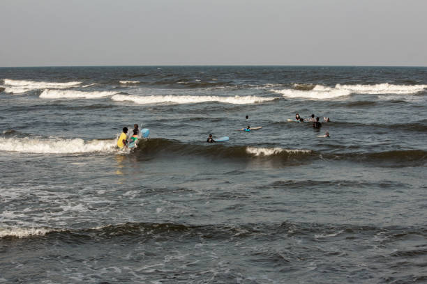 Bureh, Western, Sierra Leone – May 13, 2014: Members of the Bureh Beach Surf Club with new surfboard from France. The Surf Club offers rental boards, food and drinks to visitors.
