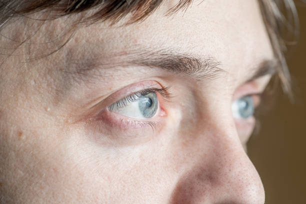 istock light gray-blue eye looks away. Close-up 1301268179