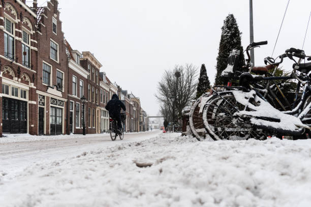 istock A man on a bycycle in a snowy street 1301269407