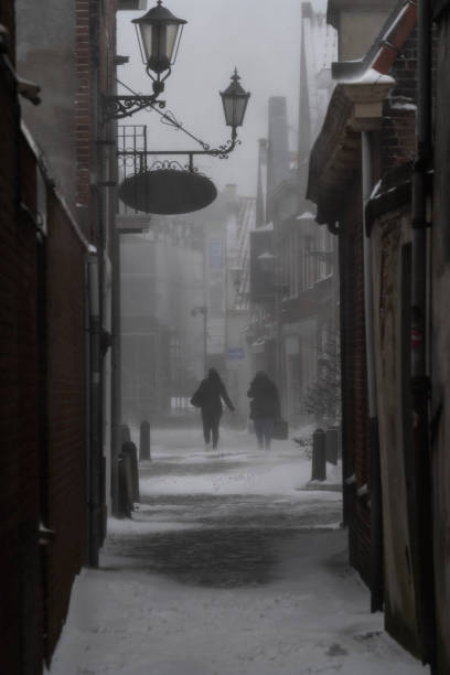 istock two people in a alley in the snow 1301269410