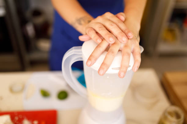 istock Crossed female hands holding blender lid 1301269788