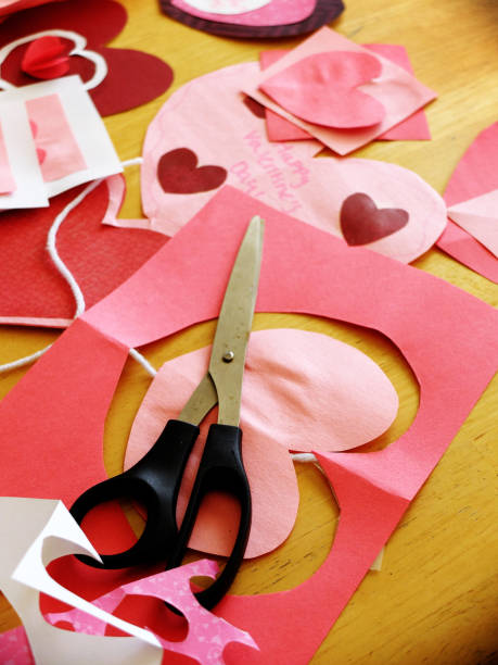 istock Homemade Valentines hearts and cards on table with scissors crafts creative 1301271053