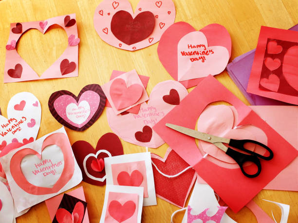 istock Homemade Valentines hearts and cards on table with scissors crafts creative 1301271085