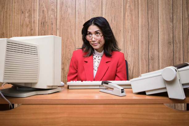 Retro Secretary At Computer Desk In Vintage Office