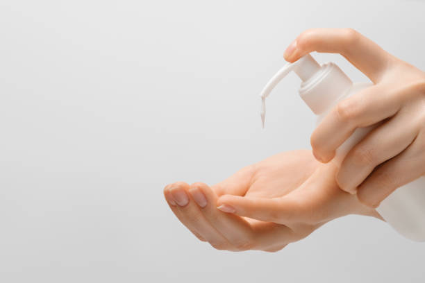 istock A woman's hands on a gray background squeeze hand cream to moisturize her hands and protect them from the outside world. 1301273121