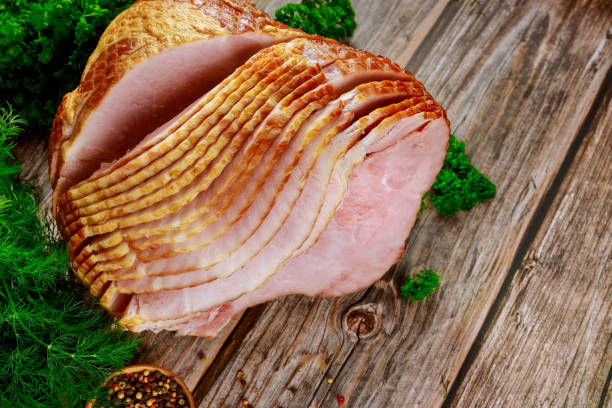 istock Pork ham sliced with herb on wooden background. 1301273127