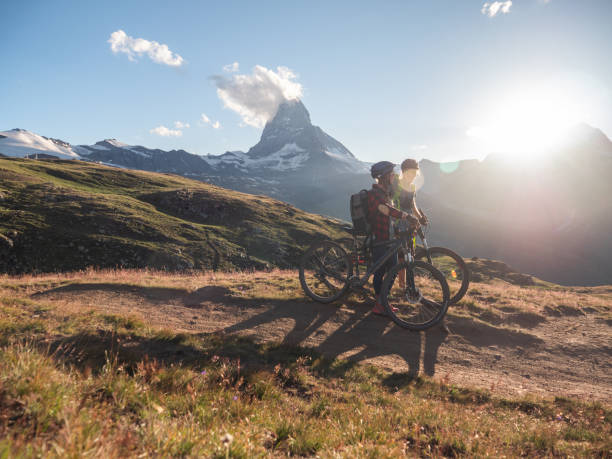 istock Mountain bikers contemplates the Matterhorn in distance 1301275236