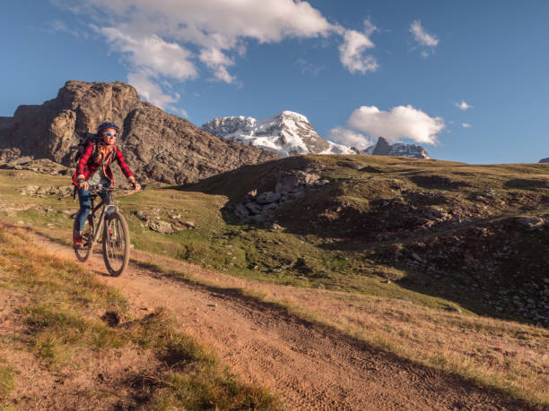 istock Mountain biker on dirt trail, Switzerland 1301275238