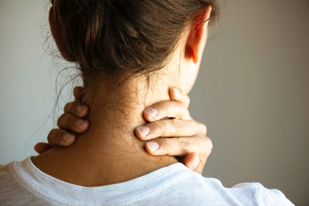 Woman With Neck Pain Back view of unrecognizable woman with neck pain. neck stock pictures, royalty-free photos & images