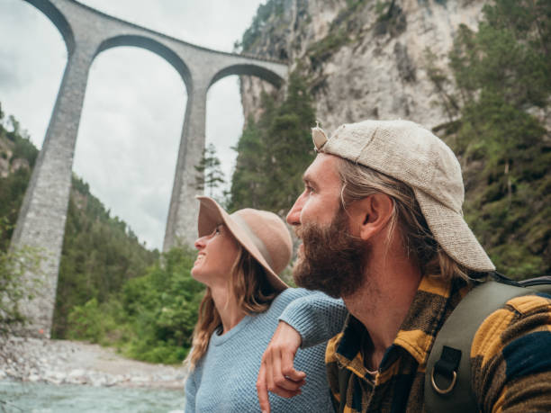 istock Couple contemplate viaduct from the river below, Switzerland 1301276328