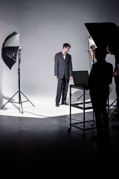 istock People Working Behind the Scenes while Filming on a Film Set 1301276443