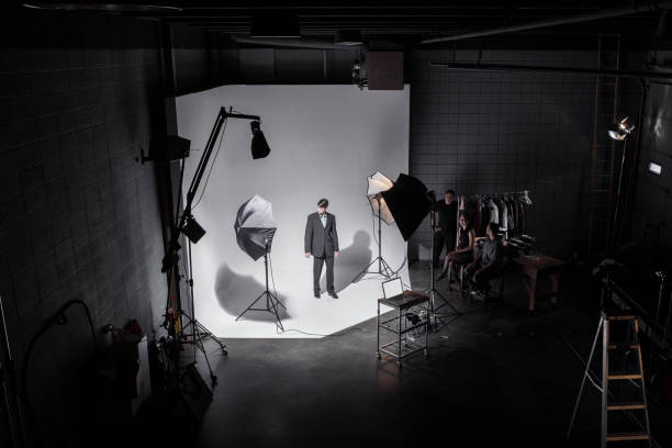 istock People Working Behind the Scenes while Filming on a Film Set 1301276444
