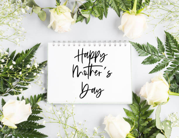 istock Open white notebook with white page in floral frame. Happy mothers day 1301276486