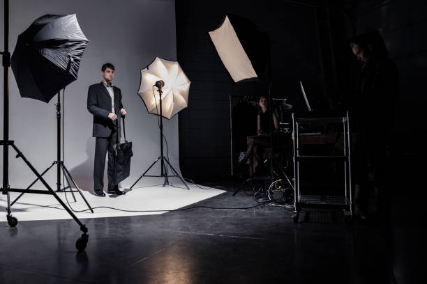 istock People Working Behind the Scenes while Filming on a Film Set 1301276505
