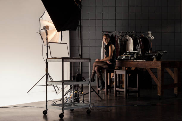 istock Makeup Artist Working Behind the Scenes while Filming on a Film Set 1301276557