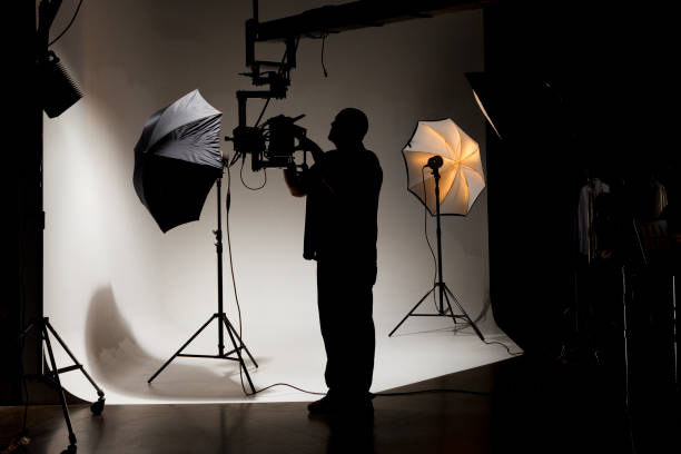 istock Camera Operator Working Behind the Scenes while Filming on a Film Set 1301276581