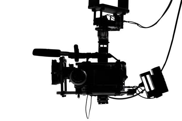 Silhouette of a movie camera on a crane while filming a film production.