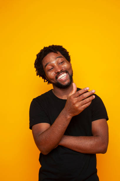 istock young handsome african american guy student posing cheerful and gesturing on yellow background, lifestyle people concept 1301276769