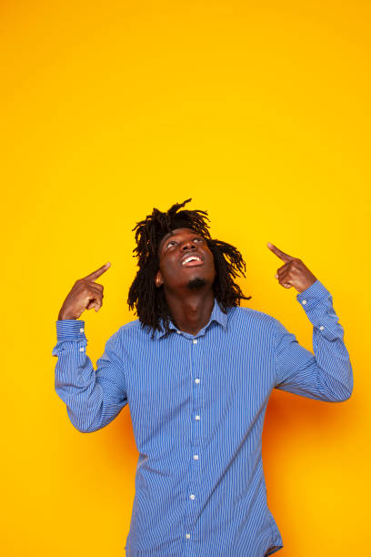 istock young handsome african american guy student posing cheerful and gesturing on yellow background, lifestyle people concept 1301276811