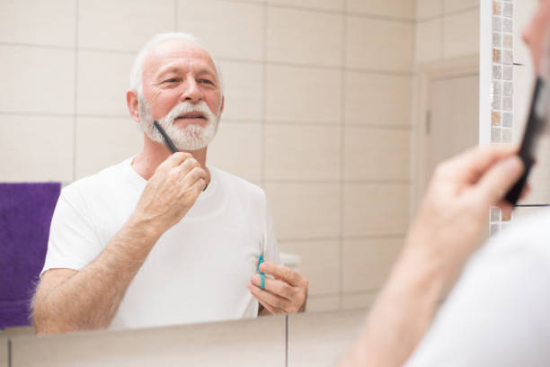 istock Senior man cutting beard in the bathroom 1301278246