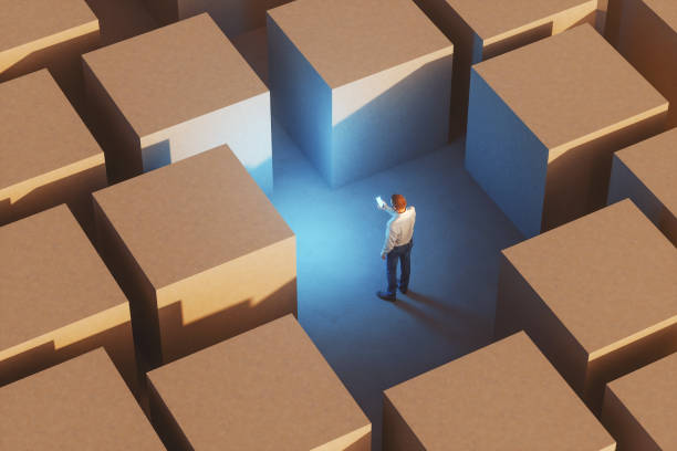 istock Businessman with mobile phone lost in concrete maze 1301278550