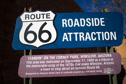 Winslow, AZ: A sign announcing a Route 66 roadside attraction in downtown Winslow, a park dedicated to the song sung by the Eagles: Standin’ on a Corner in Winslow, Arizona.