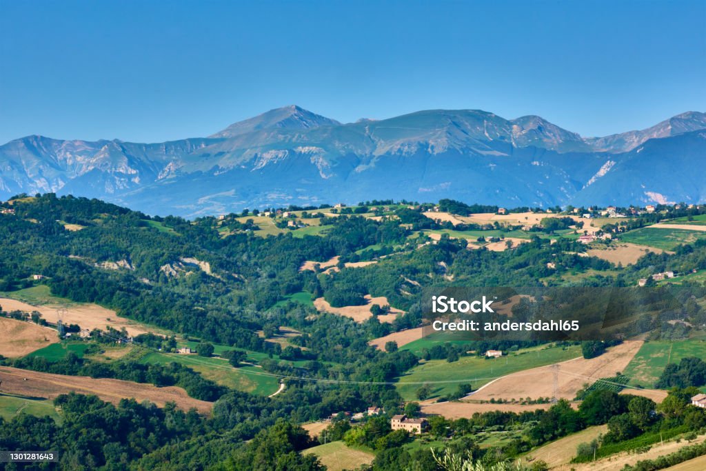 The hills of Le Marche with Monti Sibillini in the background A beautiful view to the hills of Le Marche with the Monti Sibillini in the background Marche - Italy Stock Photo