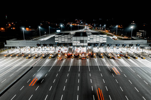 istock Aerial drone view on toll collection point on motorway at night. 1301282831