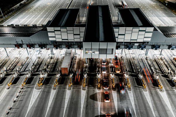 istock Pay toll collection point on highway at night seen from a helicopter 1301282880