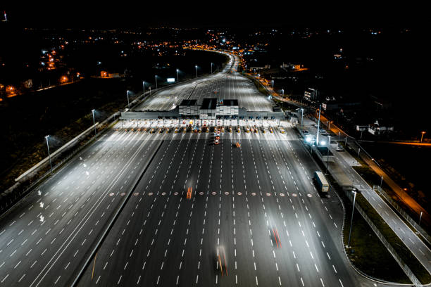 istock Pay toll station on highway at night seen from a helicopter 1301282899
