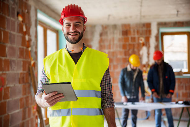 istock Caucasian Construction Worker Holding Digital Tablet And Looking At Camera 1301283258