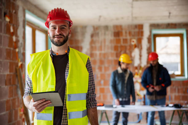 istock Caucasian Construction Worker Holding Digital Tablet And Looking At Camera 1301284199