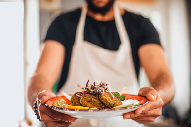 istock Chef Holding a Falafel Plate 1301284399