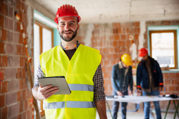 istock Caucasian Construction Worker Holding Digital Tablet And Looking At Camera 1301284436