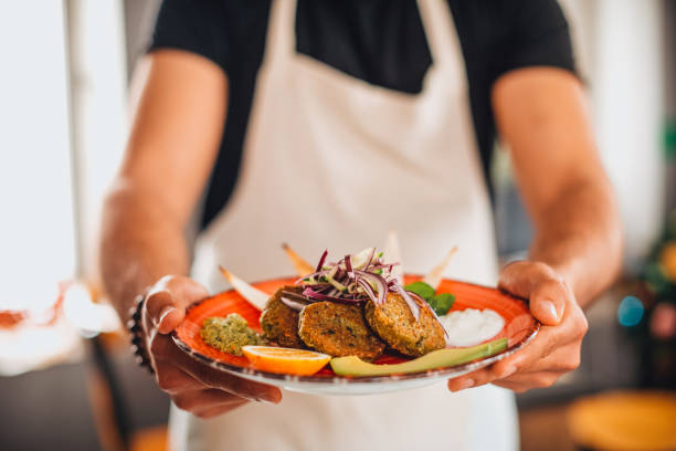 istock Chef Holding a Falafel Plate 1301284526